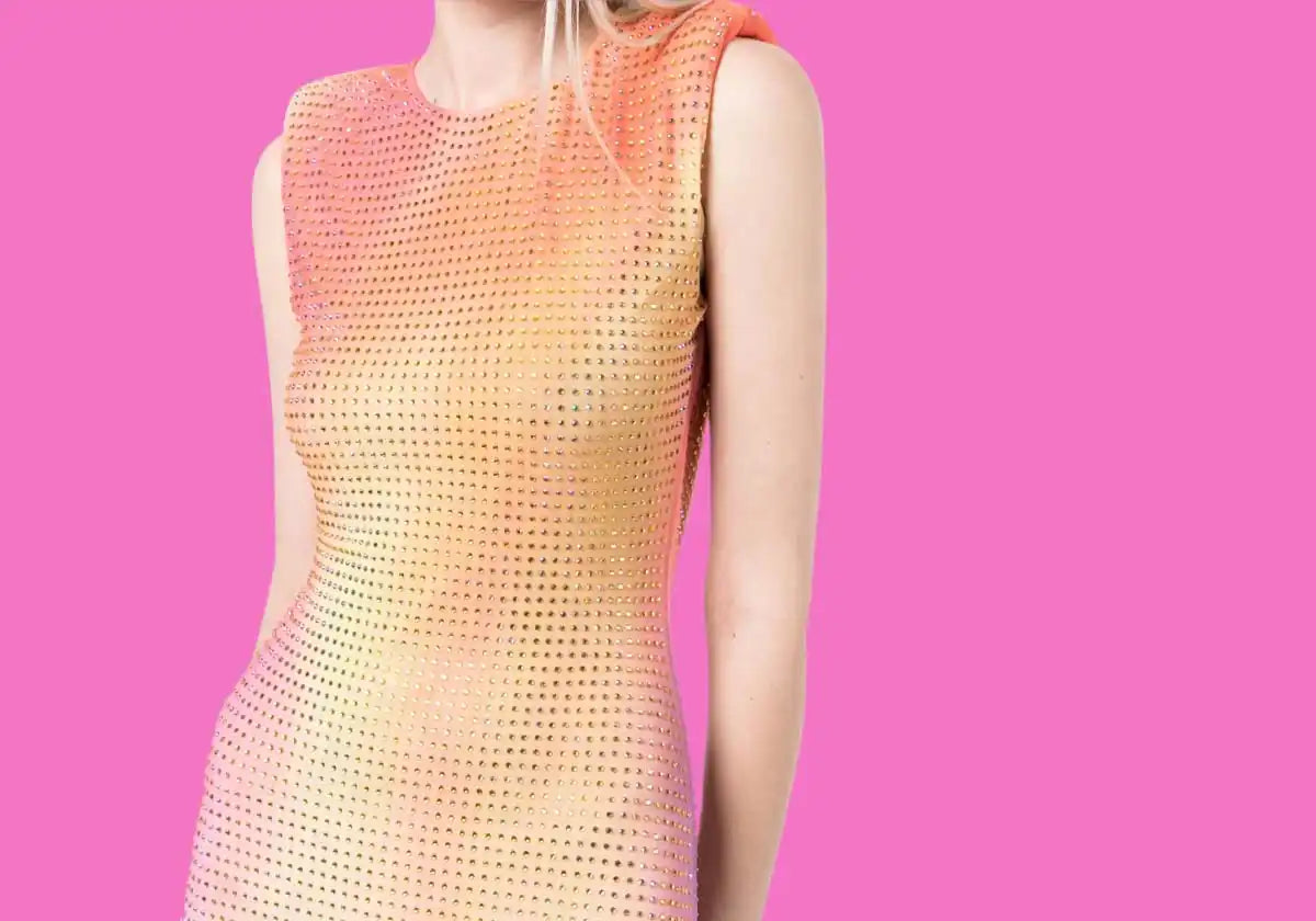A sleeveless, form-fitting, ombre-colored dress with a perforated texture.