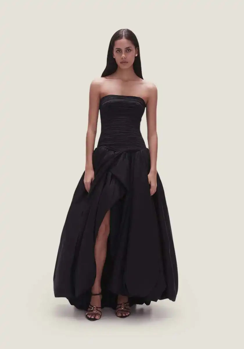Strapless black gown with a high slit.